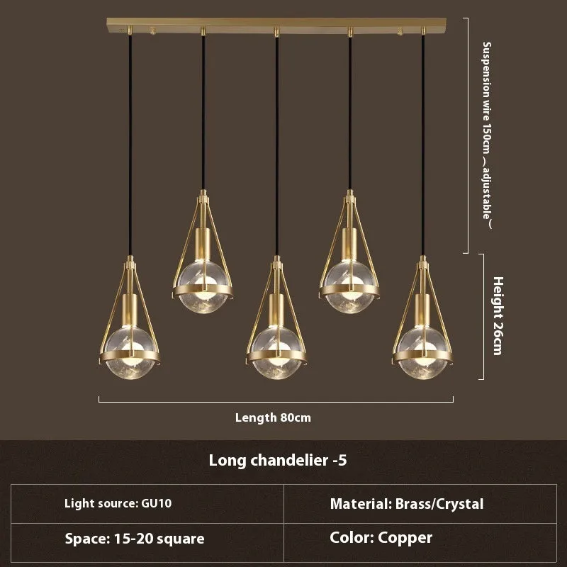 Modern copper and crystal chandelier with multiple light heads in a minimalist design.