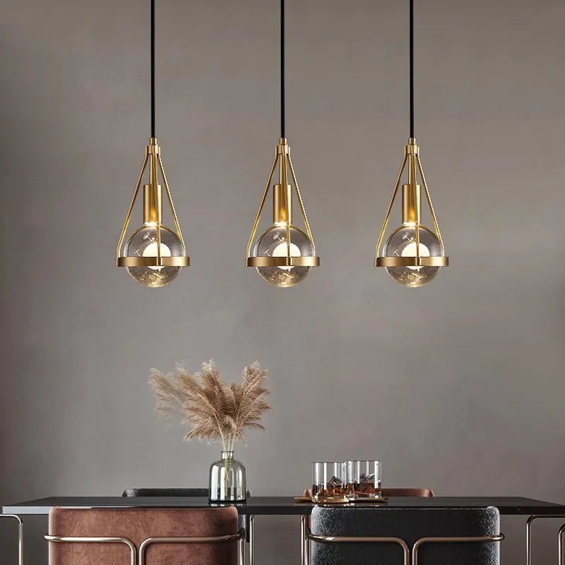 Modern copper and crystal chandelier with multiple light heads in a minimalist design.