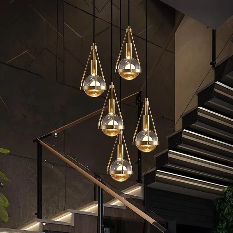 Modern copper and crystal chandelier with multiple light heads in a minimalist design.