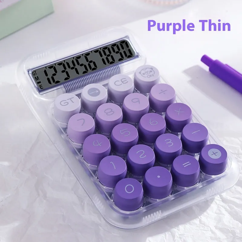 Keyboard-style gradient colour calculator in mute blue, green, pink, or purple on a desk.