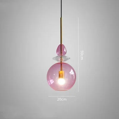 Glass chandelier with macarons and candy decoration hanging above a bar counter