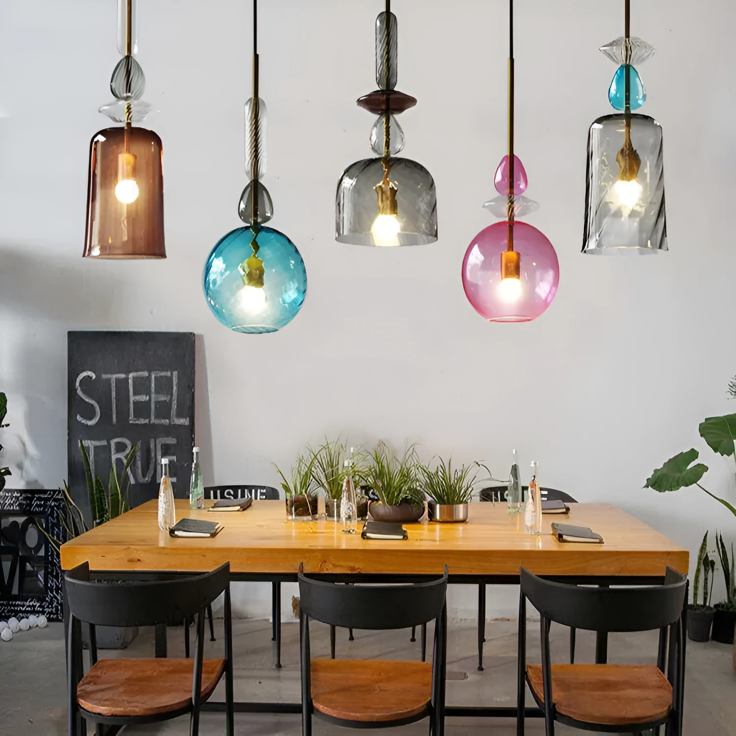 Glass chandelier with macarons and candy decoration hanging above a bar counter