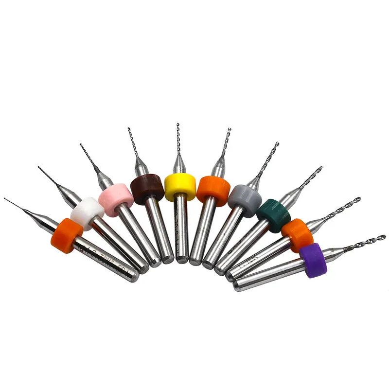 Ten tungsten carbide PCB drill bits with straight shanks on a white background
