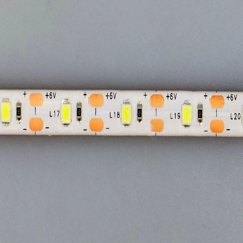 Flexible silicone USB LED light strip bent into a curve, showing touch control button and 3M adhesive backing.