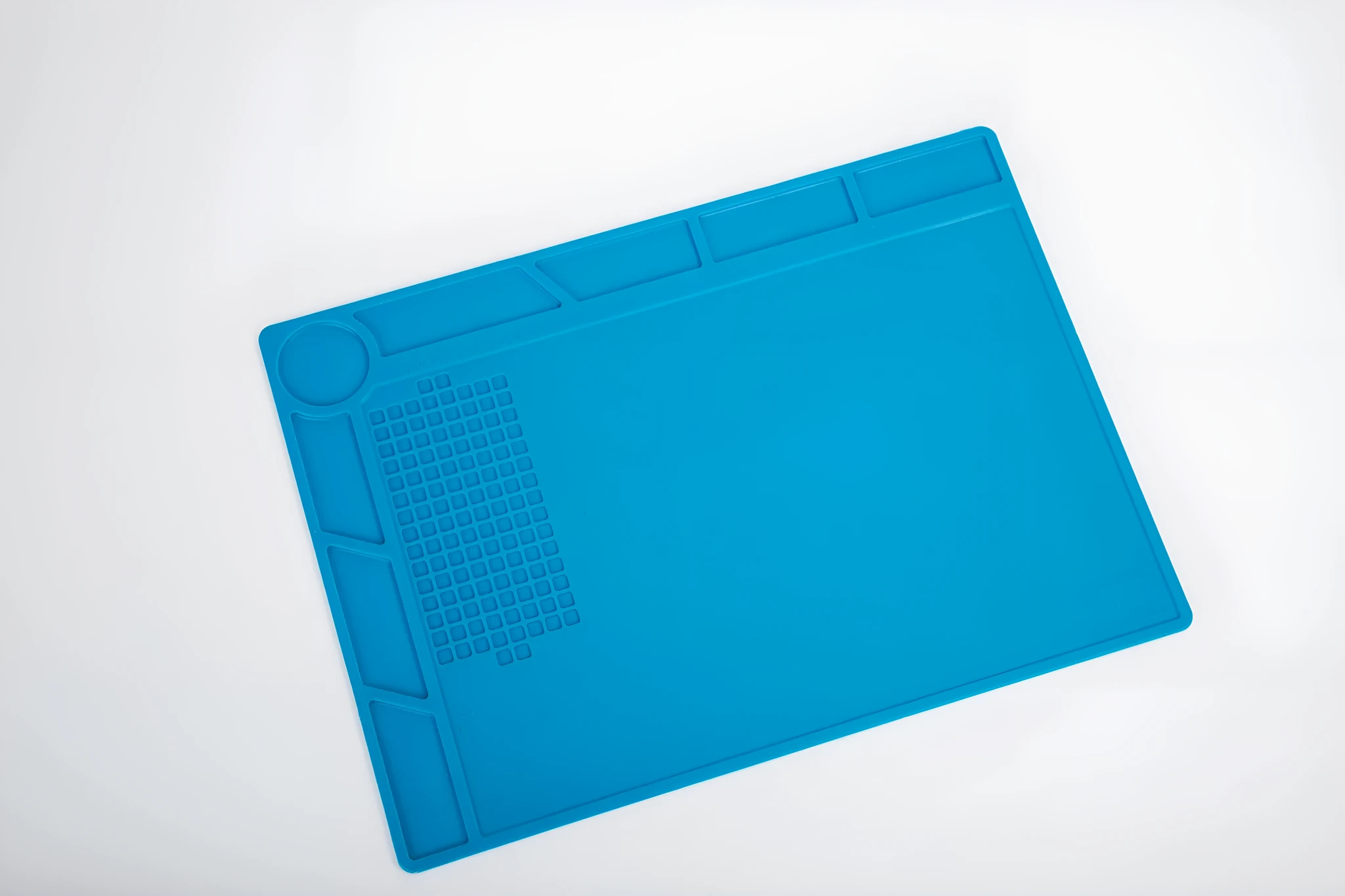 Blue silicone watch repair desk mat with anti-skid surface for timepiece maintenance
