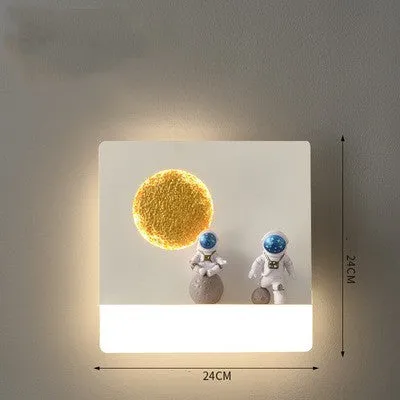 Modern black or white astronaut-shaped wall lamp with integrated shelf and LED light for bedside use.