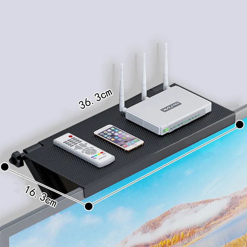 Plastic hook-mount rack holding a set-top box and router on a desktop.