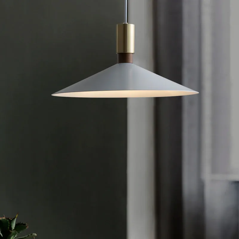 Minimalist round single-headed iron pendant lamp in black, shown in a dining setting.