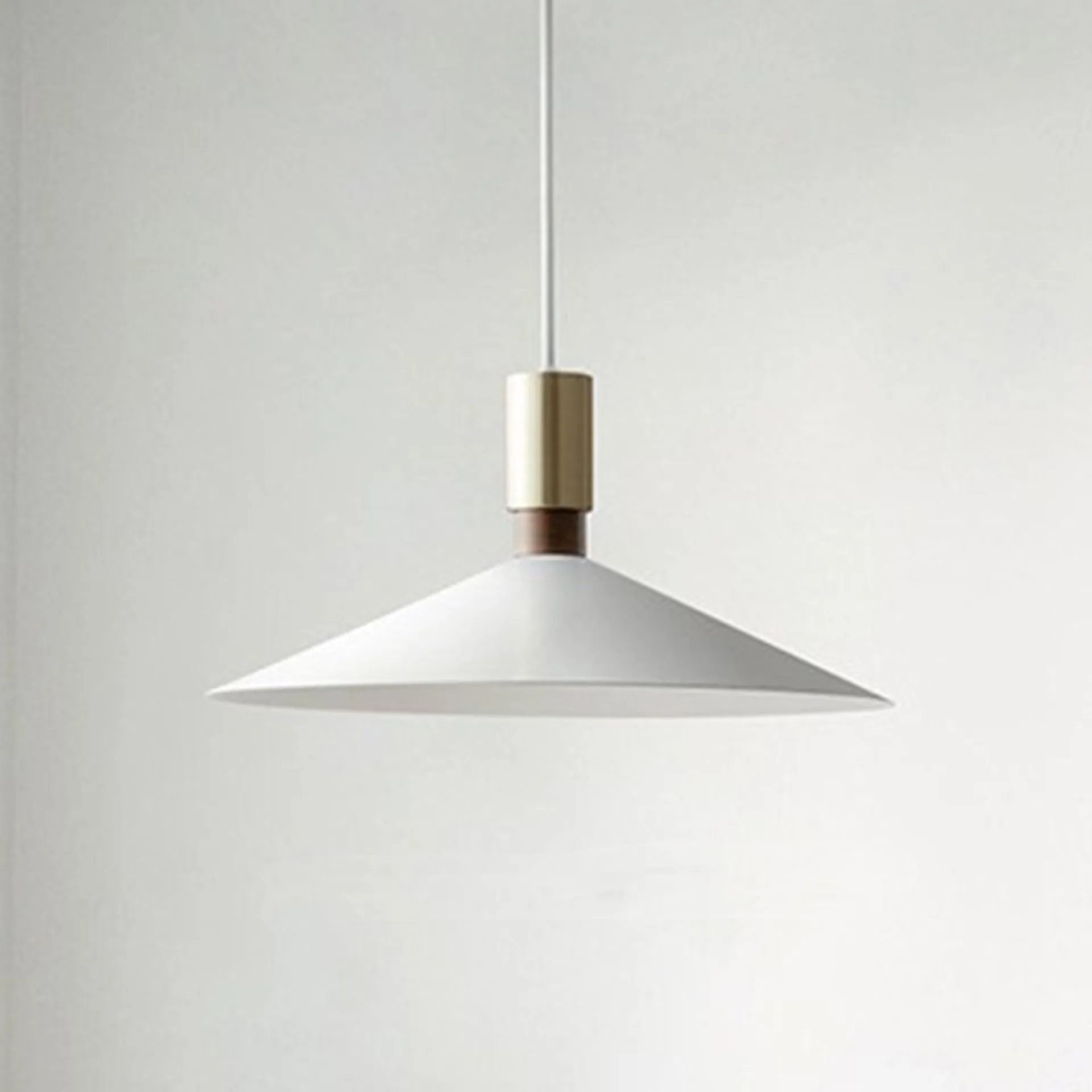 Minimalist round single-headed iron pendant lamp in black, shown in a dining setting.