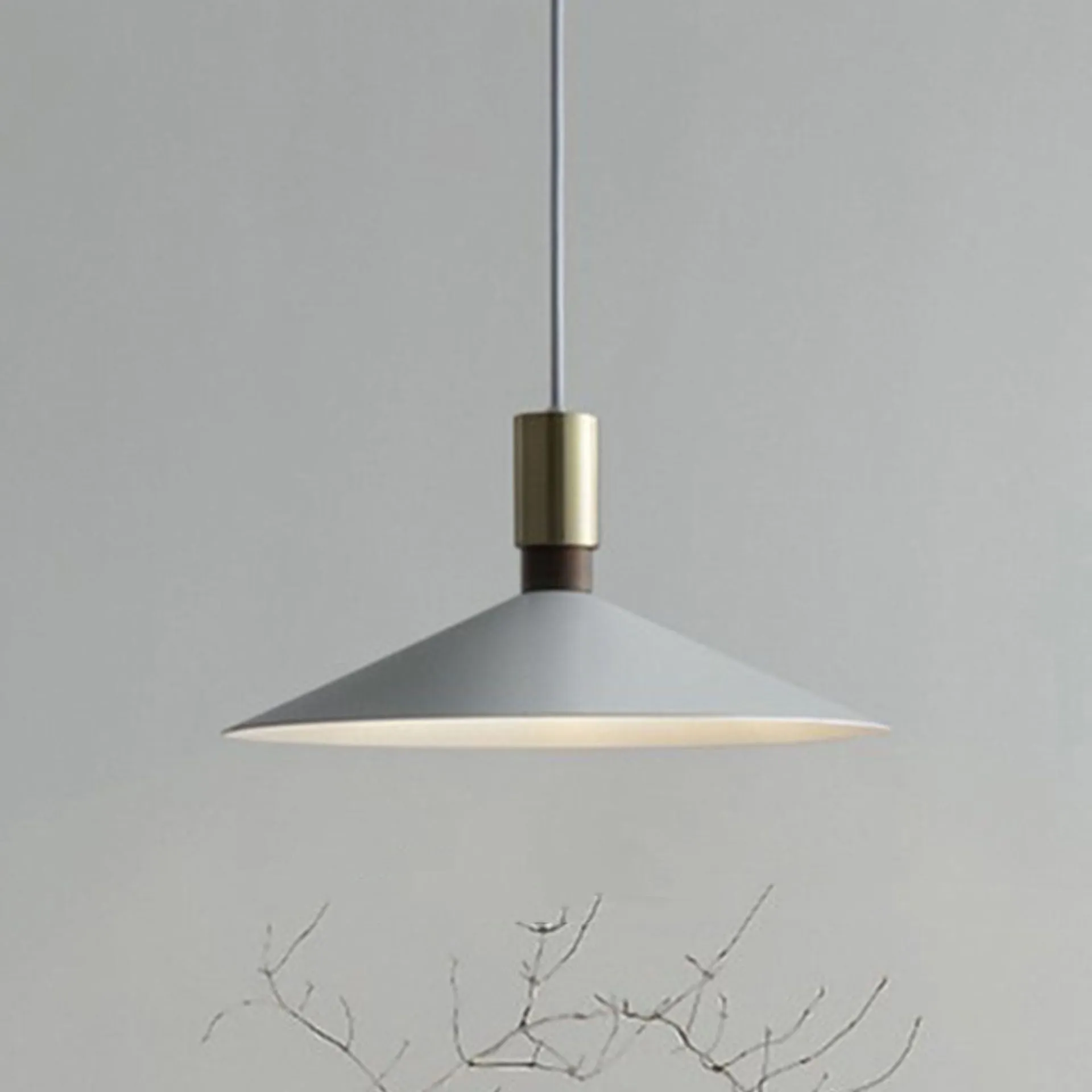 Minimalist round single-headed iron pendant lamp in black, shown in a dining setting.