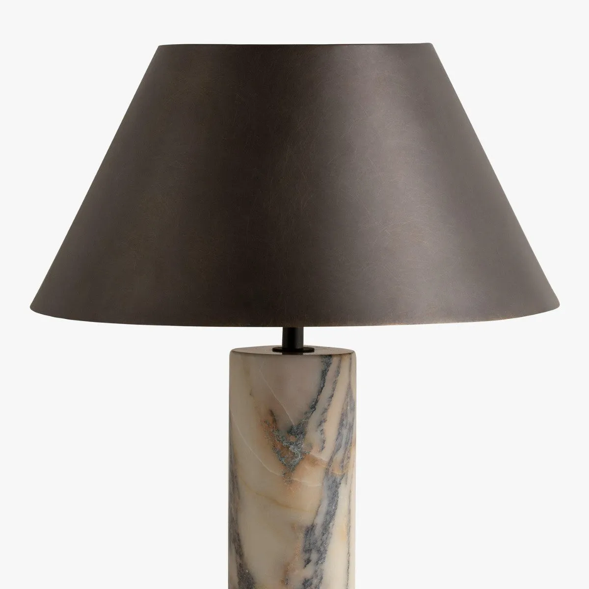Modern black table lamp with a textured marble base on a wooden desk.