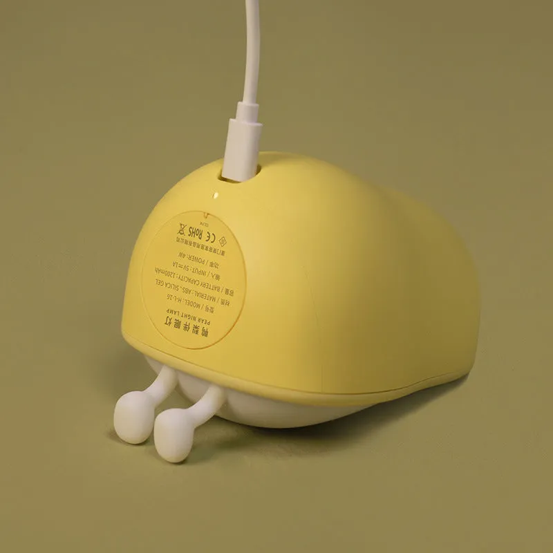 PEAR NIGHT LAMP rechargeable silicone bedside light with warm yellow glow on a surface