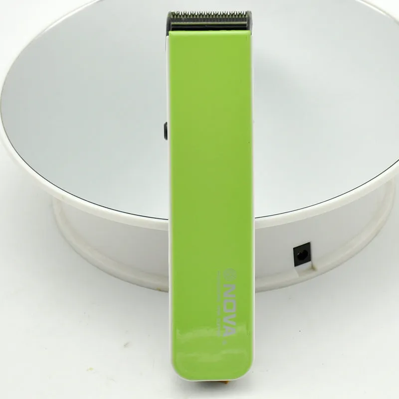 Black electric hair clipper with removable blade head on a white background.