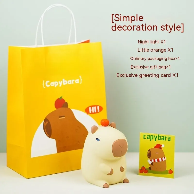 Cute brown Capybara silicone night lamp with soft glow on a bedside table.