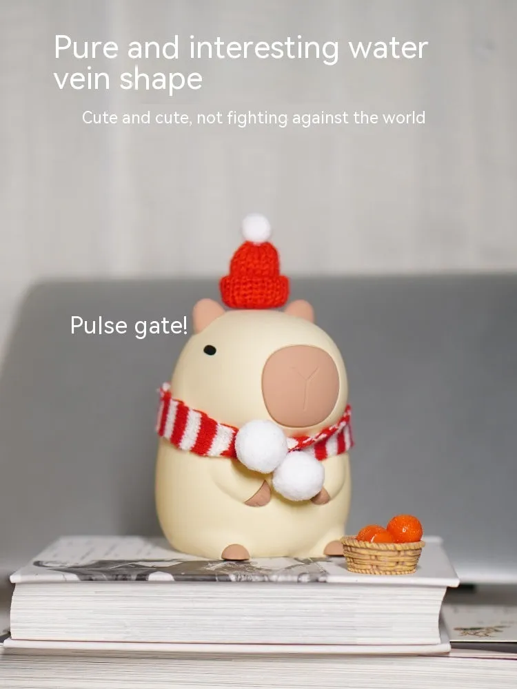 Cute brown Capybara silicone night lamp with soft glow on a bedside table.