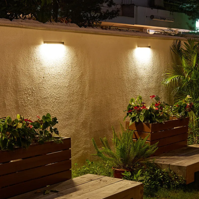 Black solar-powered outdoor wall lamp with integrated solar panel and LED light.