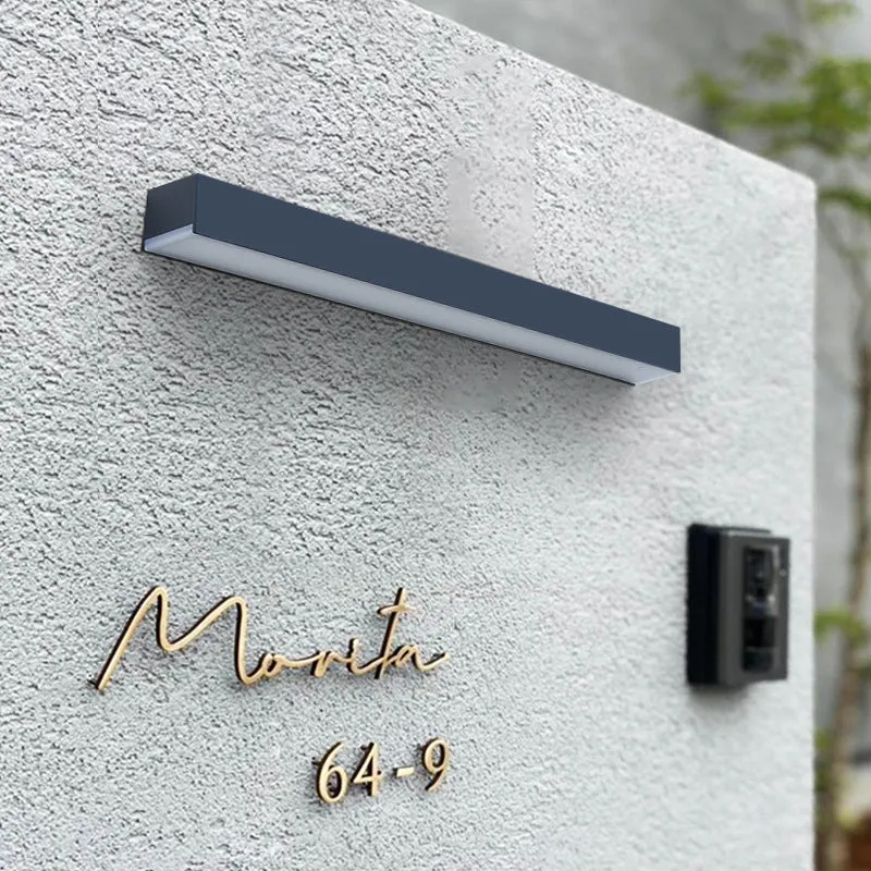 Black solar-powered outdoor wall lamp with integrated solar panel and LED light.