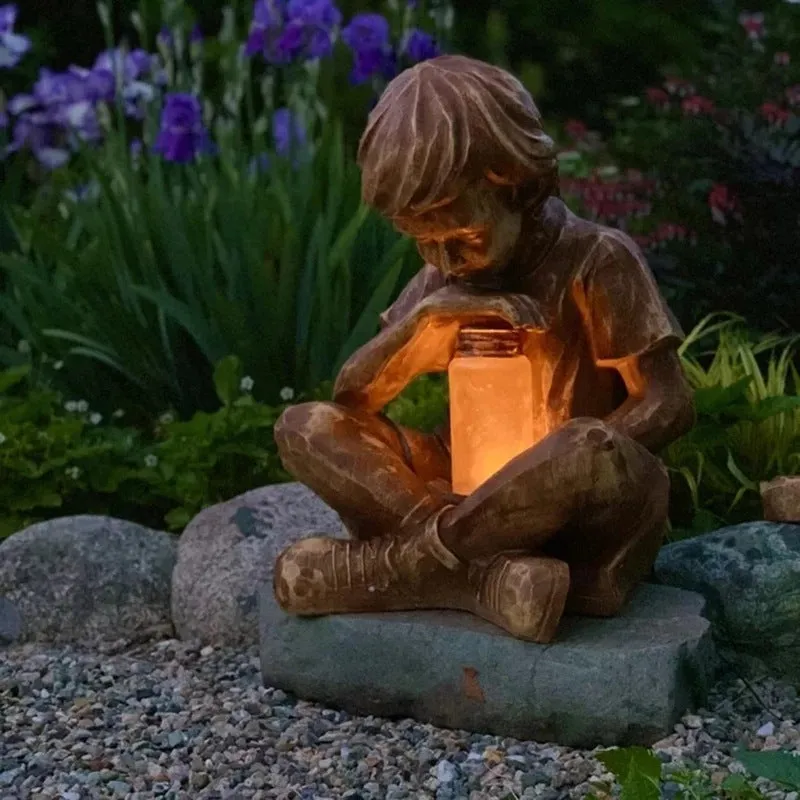 Brown natural resin statue of a little boy garden ornament for tabletop decoration.