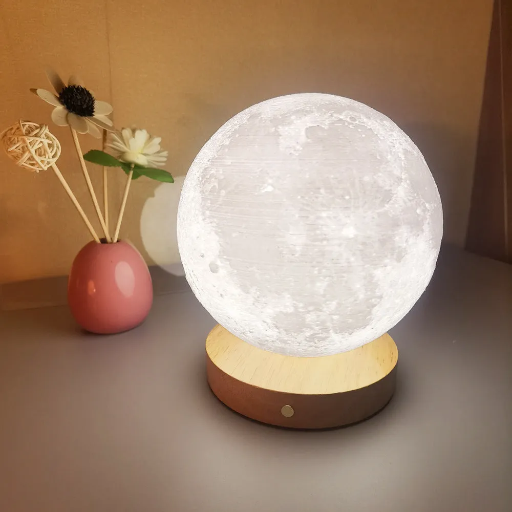 Rotating moon night light on a wooden base with a wire remote, shown in three available sizes.