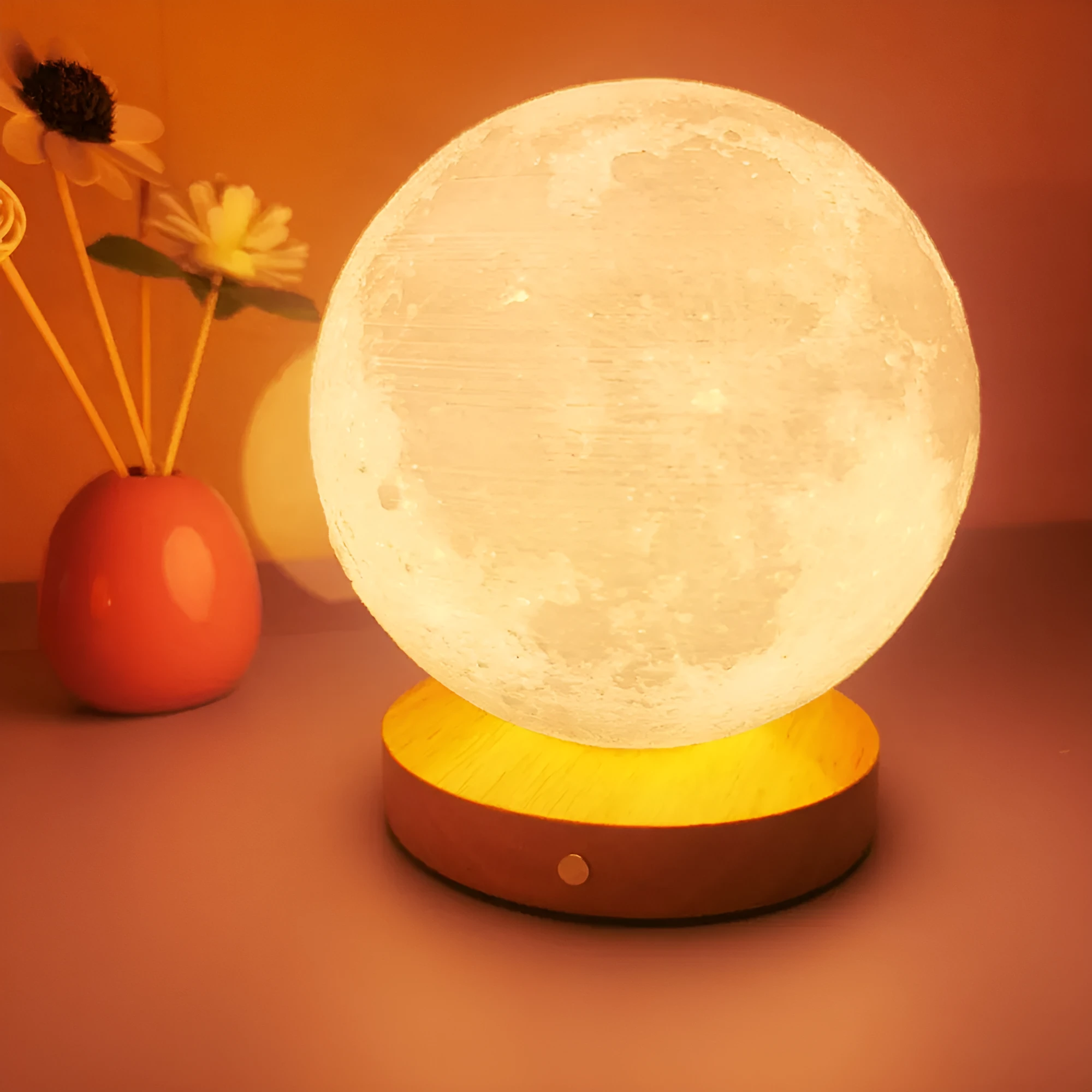 Rotating moon night light on a wooden base with a wire remote, shown in three available sizes.