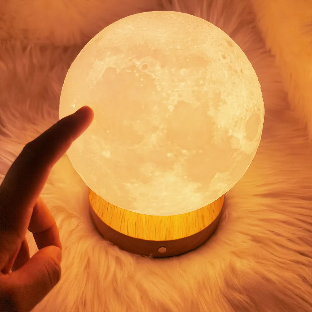 Rotating moon night light on a wooden base with a wire remote, shown in three available sizes.