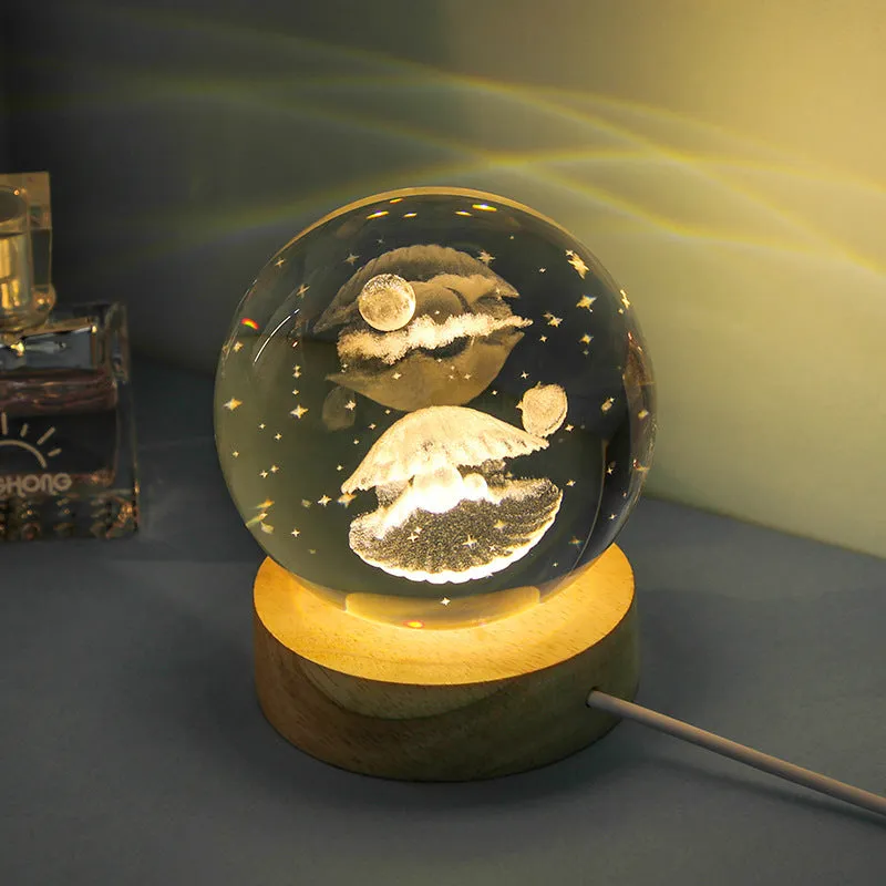 Transparent crystal ball night lamp with carved jellyfish design illuminated by internal LED light