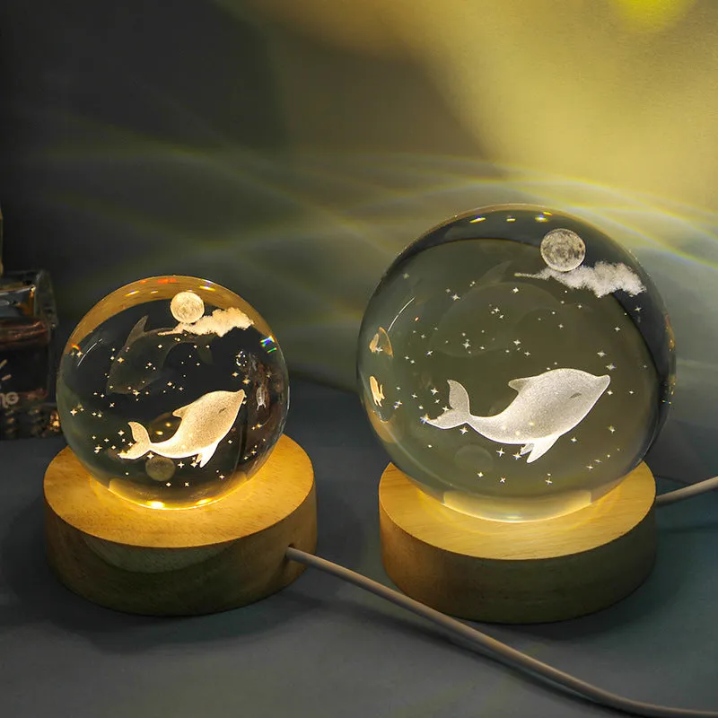 Transparent crystal ball night lamp with carved jellyfish design illuminated by internal LED light