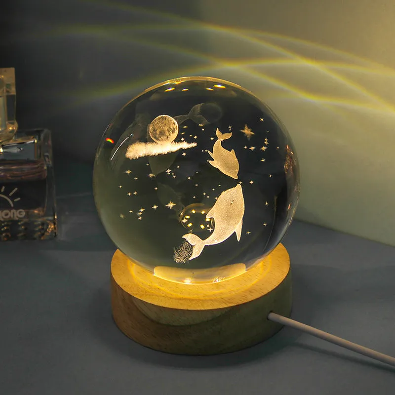 Transparent crystal ball night lamp with carved jellyfish design illuminated by internal LED light