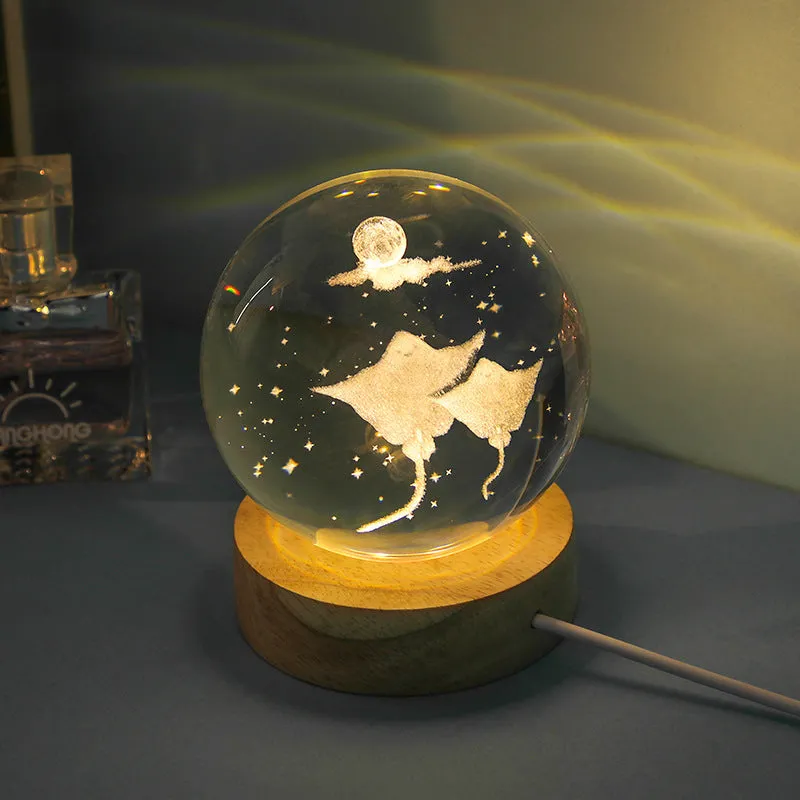 Transparent crystal ball night lamp with carved jellyfish design illuminated by internal LED light