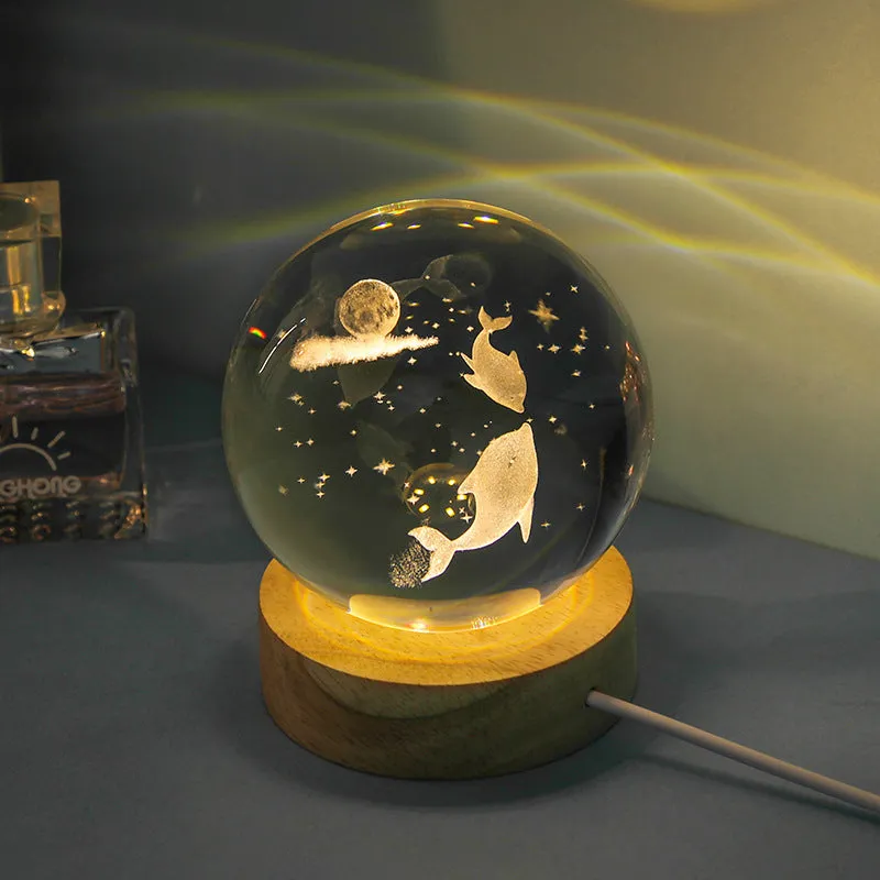 Transparent crystal ball night lamp with carved jellyfish design illuminated by internal LED light