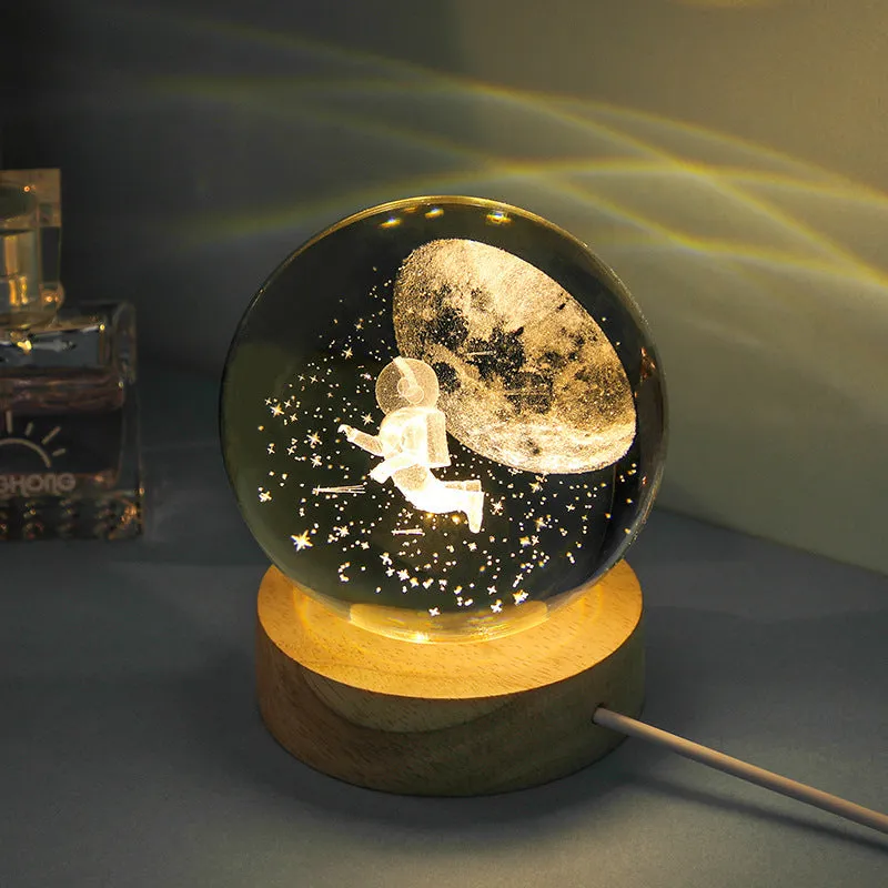 Transparent crystal ball night lamp with carved jellyfish design illuminated by internal LED light