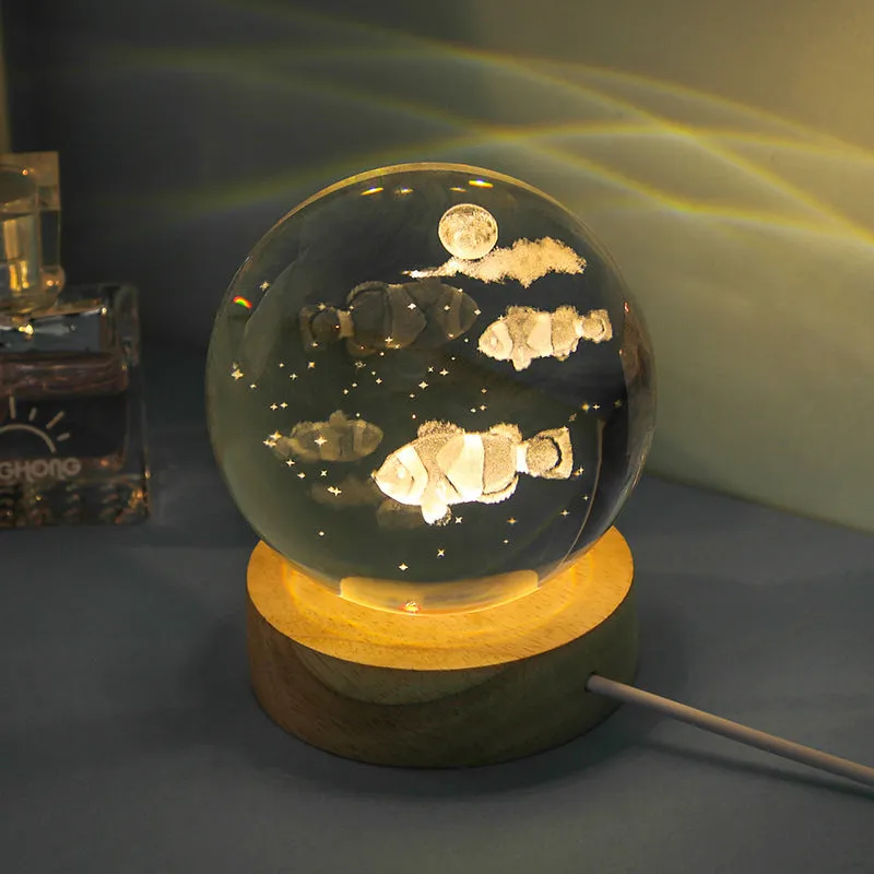 Transparent crystal ball night lamp with carved jellyfish design illuminated by internal LED light