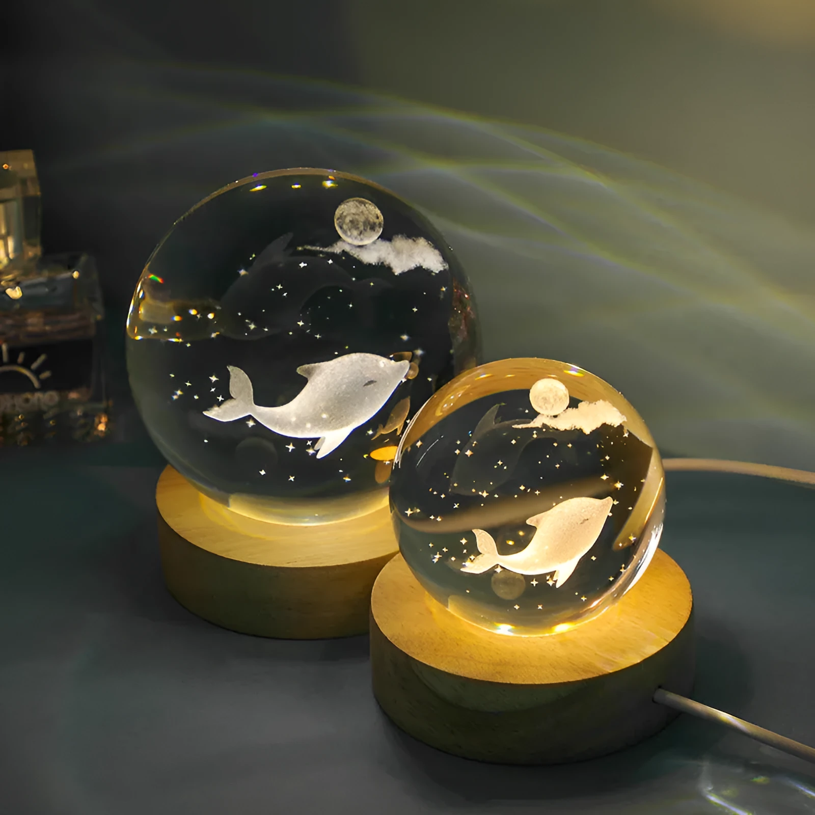 Transparent crystal ball night lamp with carved jellyfish design illuminated by internal LED light