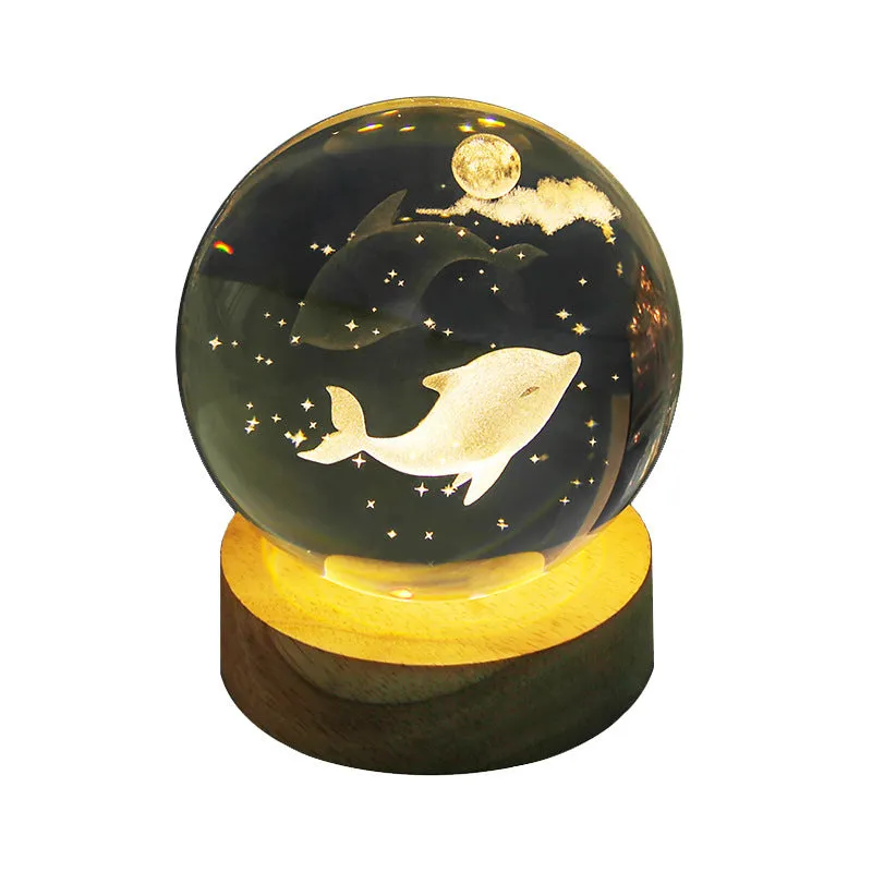Transparent crystal ball night lamp with carved jellyfish design illuminated by internal LED light