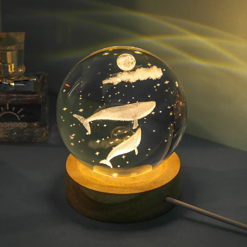 Transparent crystal ball night lamp with carved jellyfish design illuminated by internal LED light