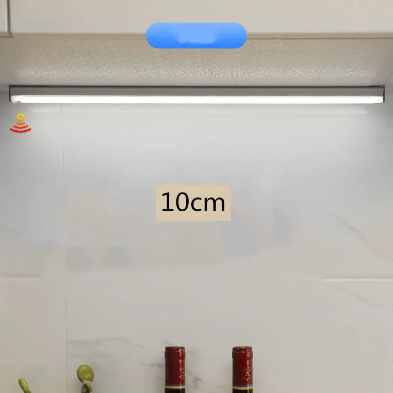 Hand-scanning rechargeable LED strip light for cabinets with magnetic and adhesive backing.