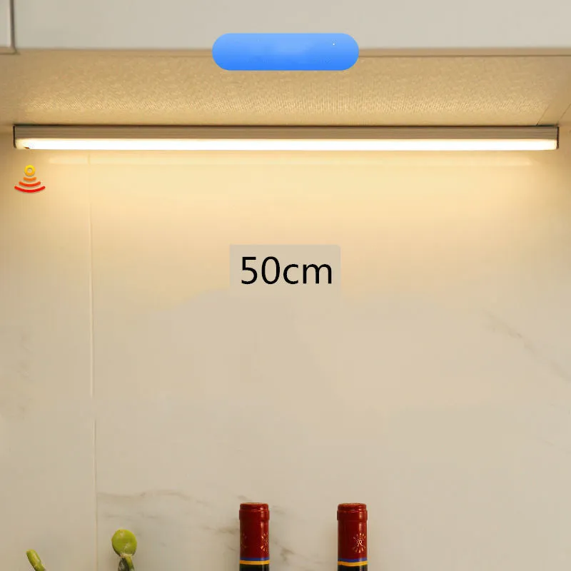 Hand-scanning rechargeable LED strip light for cabinets with magnetic and adhesive backing.