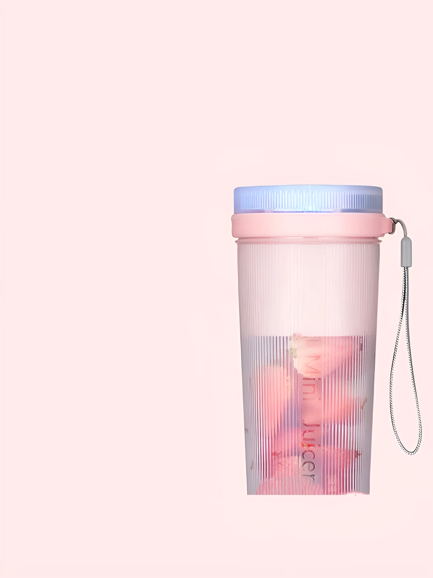 Portable pink and green rechargeable electric juicer cup with USB charging cable.