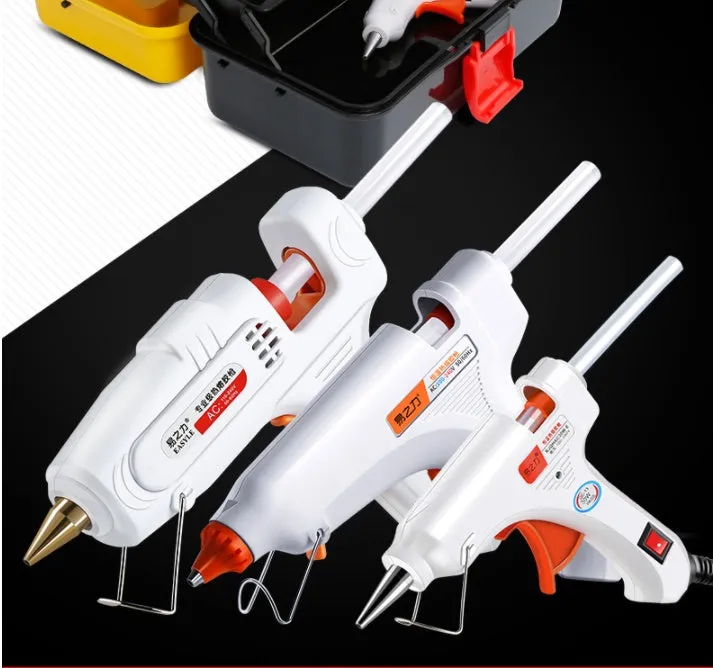 White electric hot melt glue gun with metal stand and anti-heat blanket on a work surface