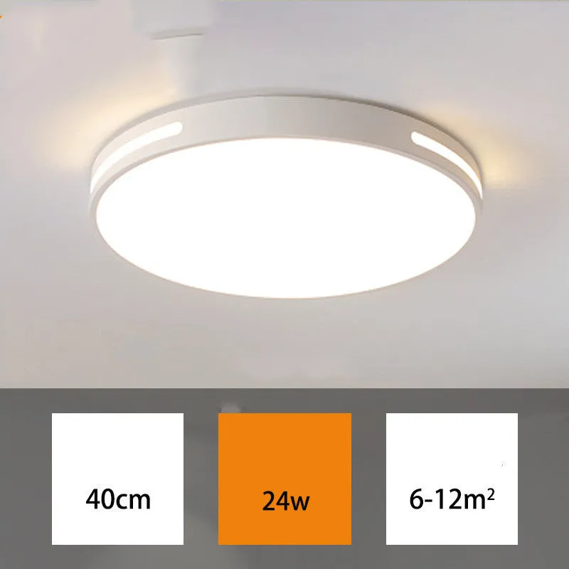 Round white acrylic remote control LED ceiling lamp mounted on a bedroom ceiling.
