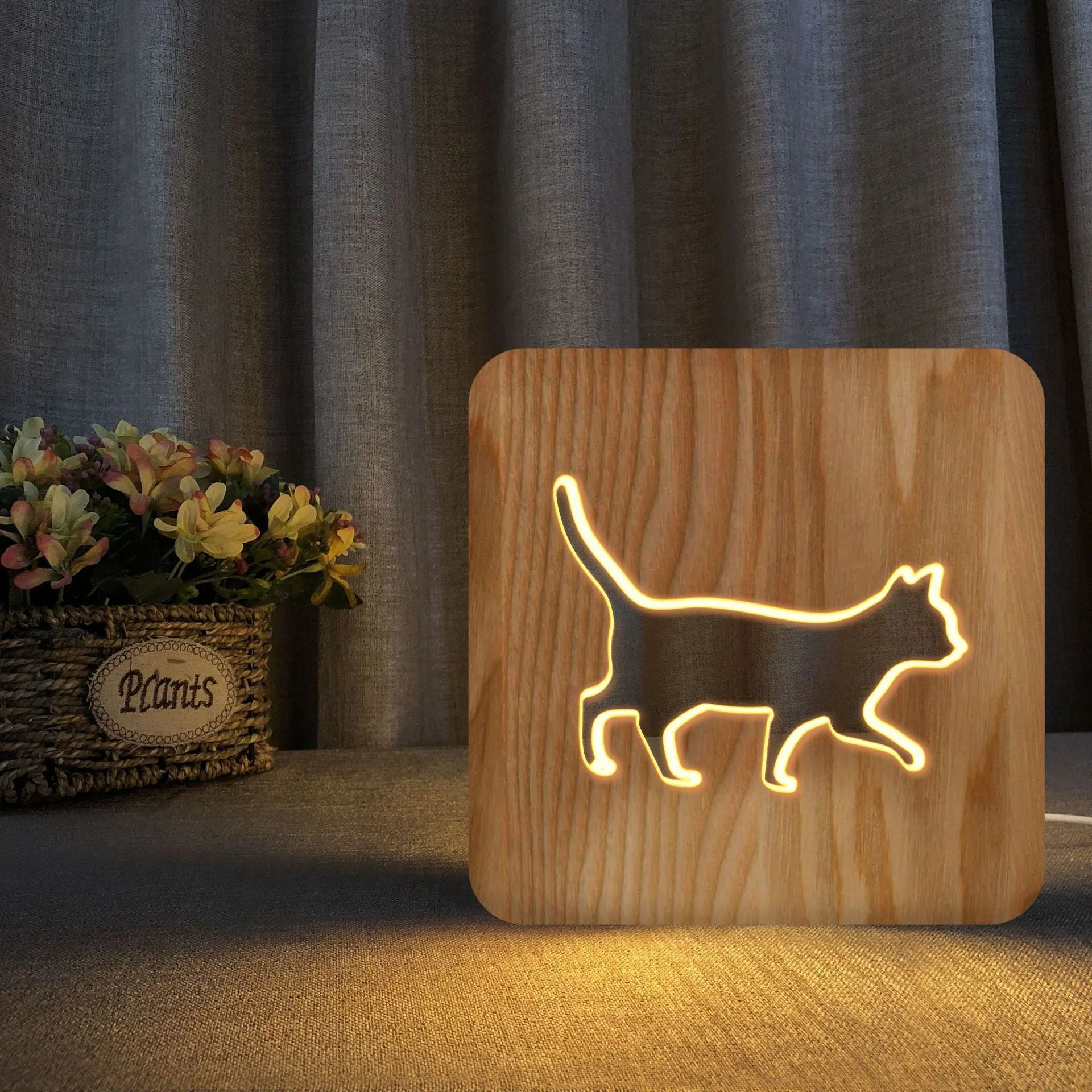 Solid wood cat-shaped 3D night light with hollow silhouette, lit with warm glow.