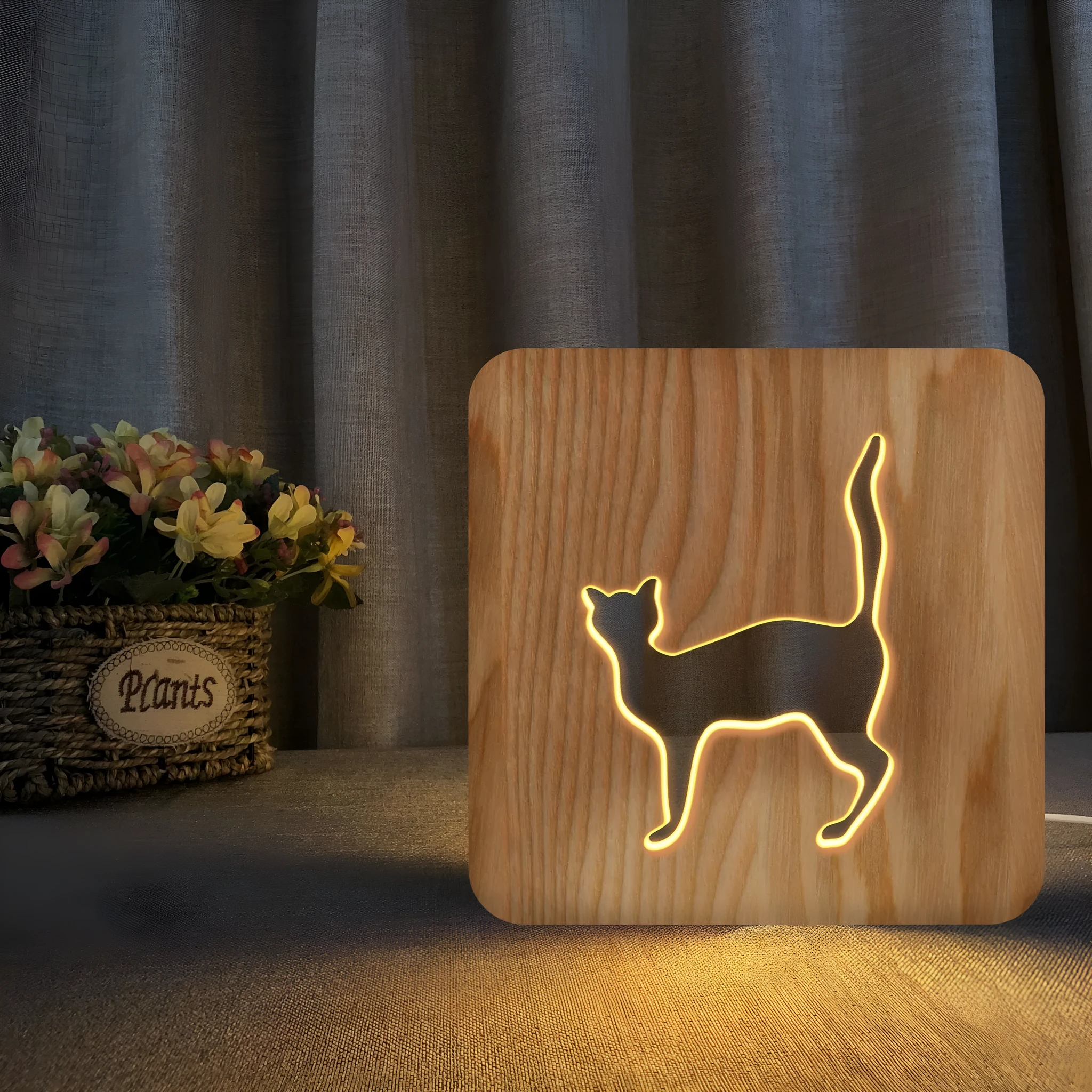 Solid wood cat-shaped 3D night light with hollow silhouette, lit with warm glow.