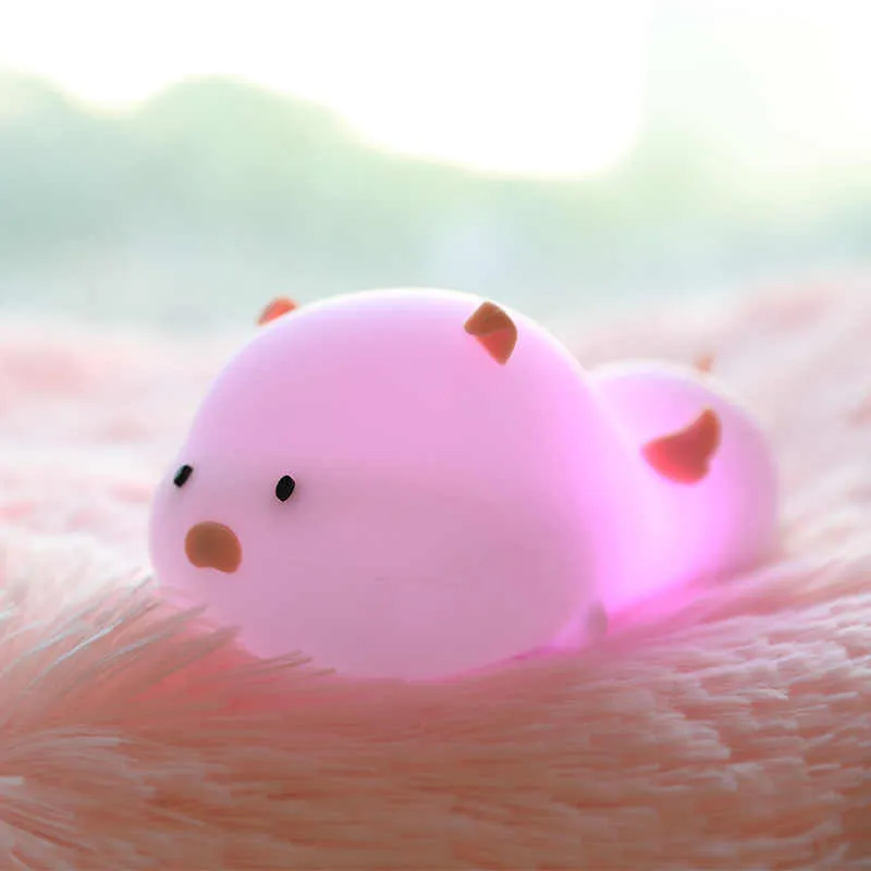 Blue rechargeable silicone night light shaped like a sleeping pig with soft LED glow.