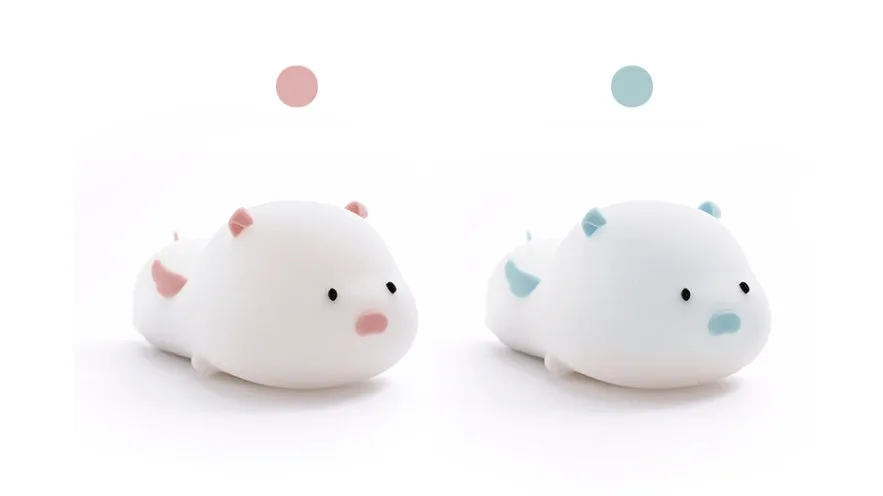Blue rechargeable silicone night light shaped like a sleeping pig with soft LED glow.