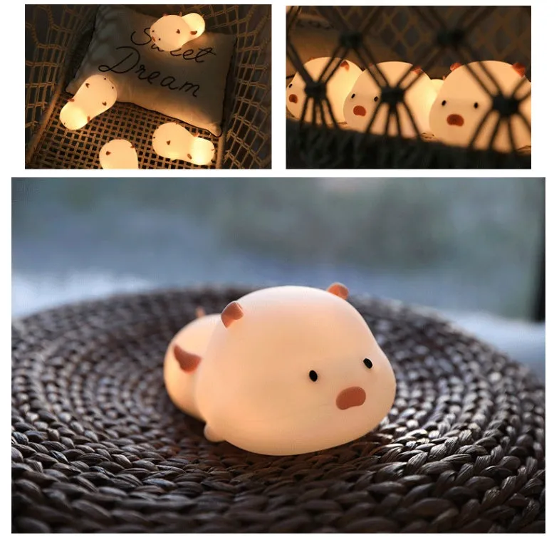 Blue rechargeable silicone night light shaped like a sleeping pig with soft LED glow.