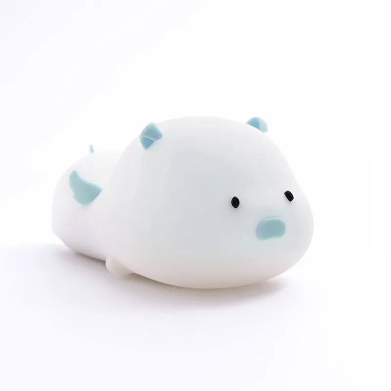 Blue rechargeable silicone night light shaped like a sleeping pig with soft LED glow.