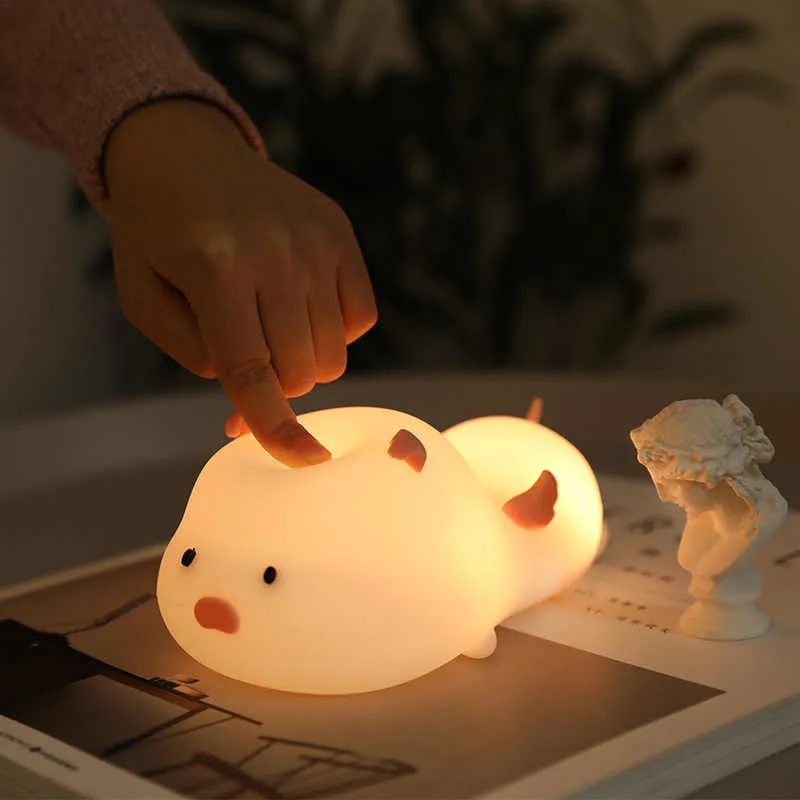 Blue rechargeable silicone night light shaped like a sleeping pig with soft LED glow.