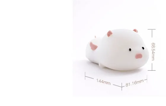 Blue rechargeable silicone night light shaped like a sleeping pig with soft LED glow.