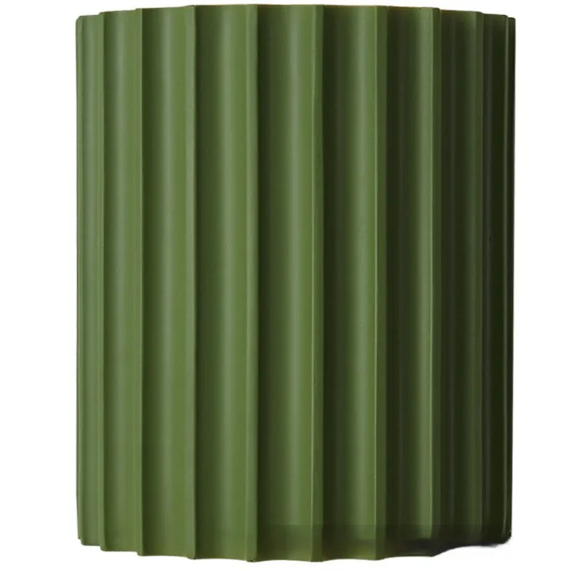 Nordic style wall light with a white macaron shell-shaped shade mounted on a hallway wall.