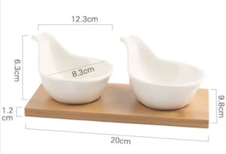 Porcelain ceramic dried fruit dish with three snack compartments on a wooden serving board.